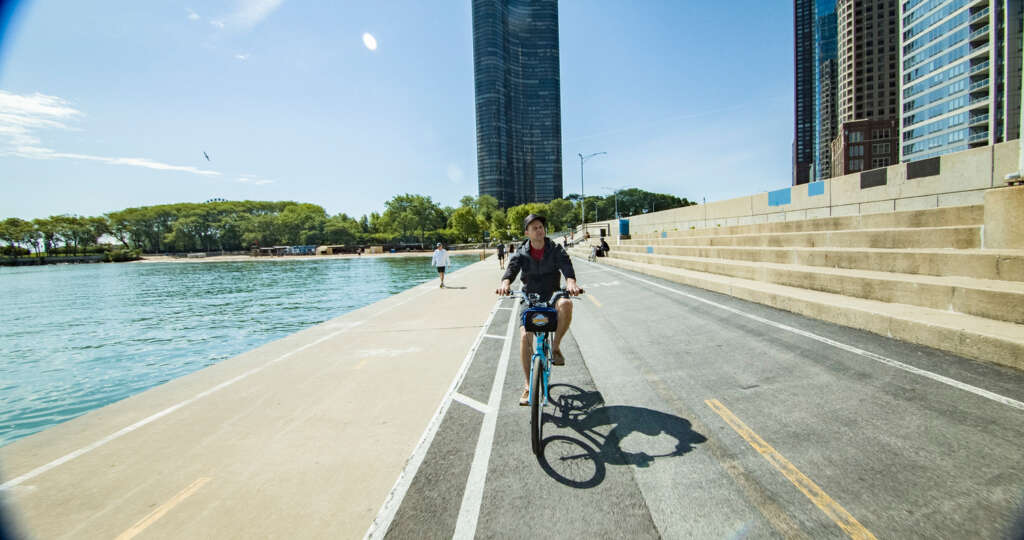 Image of Chicago Navy Pier with man biking - credit Visit the USA